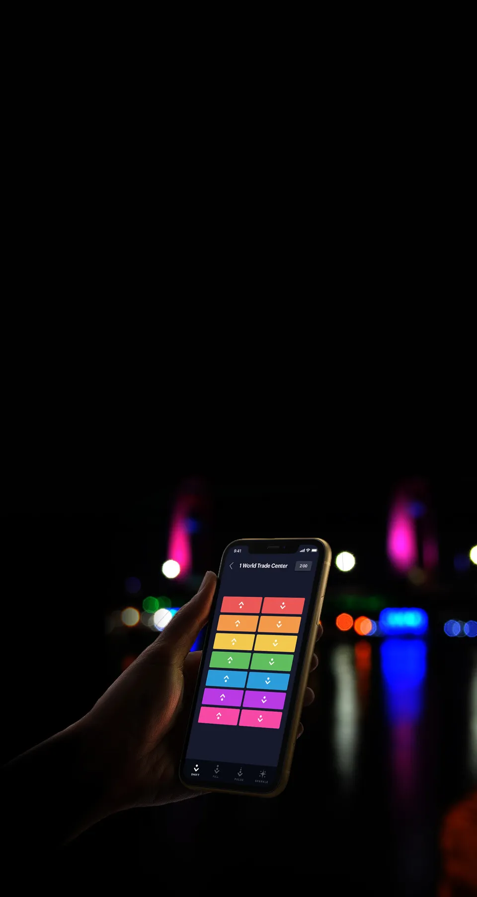 A view of a city skyline at night with illuminated spires.